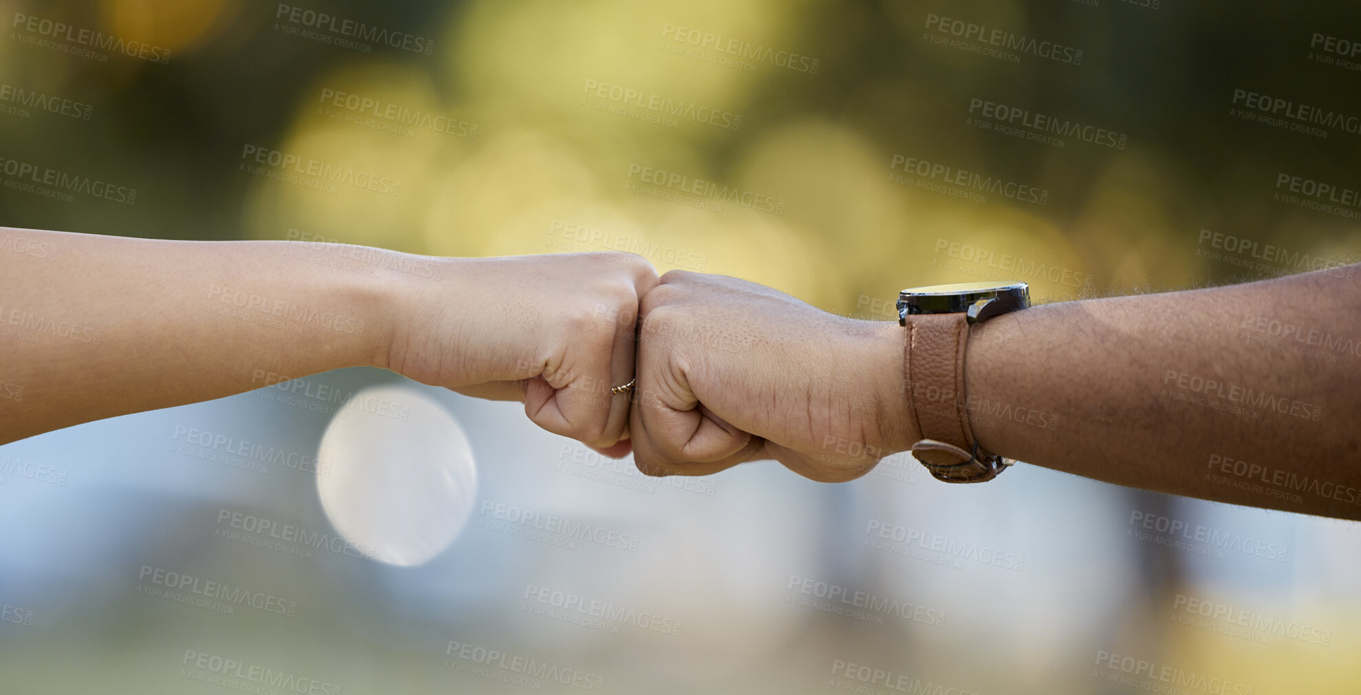 Buy stock photo Hands, motivation and fist bump with people outdoor on a blurred background for unity or solidarity. Teamwork, partnership and trust with friends outside together for team building or support