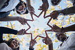 Creative people, hands and star with fingers in teamwork, solidarity or collaboration in nature. Low angle of team group touching hand together for faith, support or community, hope or startup goals