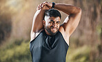 Fitness, stretching and man outdoor for training, running or workout on blurred background. Arm, stretch and Indian guy runner with body warm up in nature before exercise, run or cardio sport routine