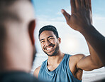 Happy man, fitness and high five for success, partnership or victory in achievement after workout in nature. Male person or men touching hands in team building, motivation or exercise goals on beach