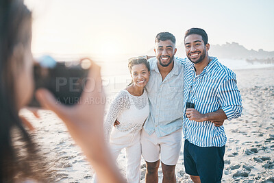 Buy stock photo Happy, photo and friends at the beach with a photographer for summer memory, holiday or bonding. Smile, camera and a woman taking a picture of a group of people at the ocean during a vacation