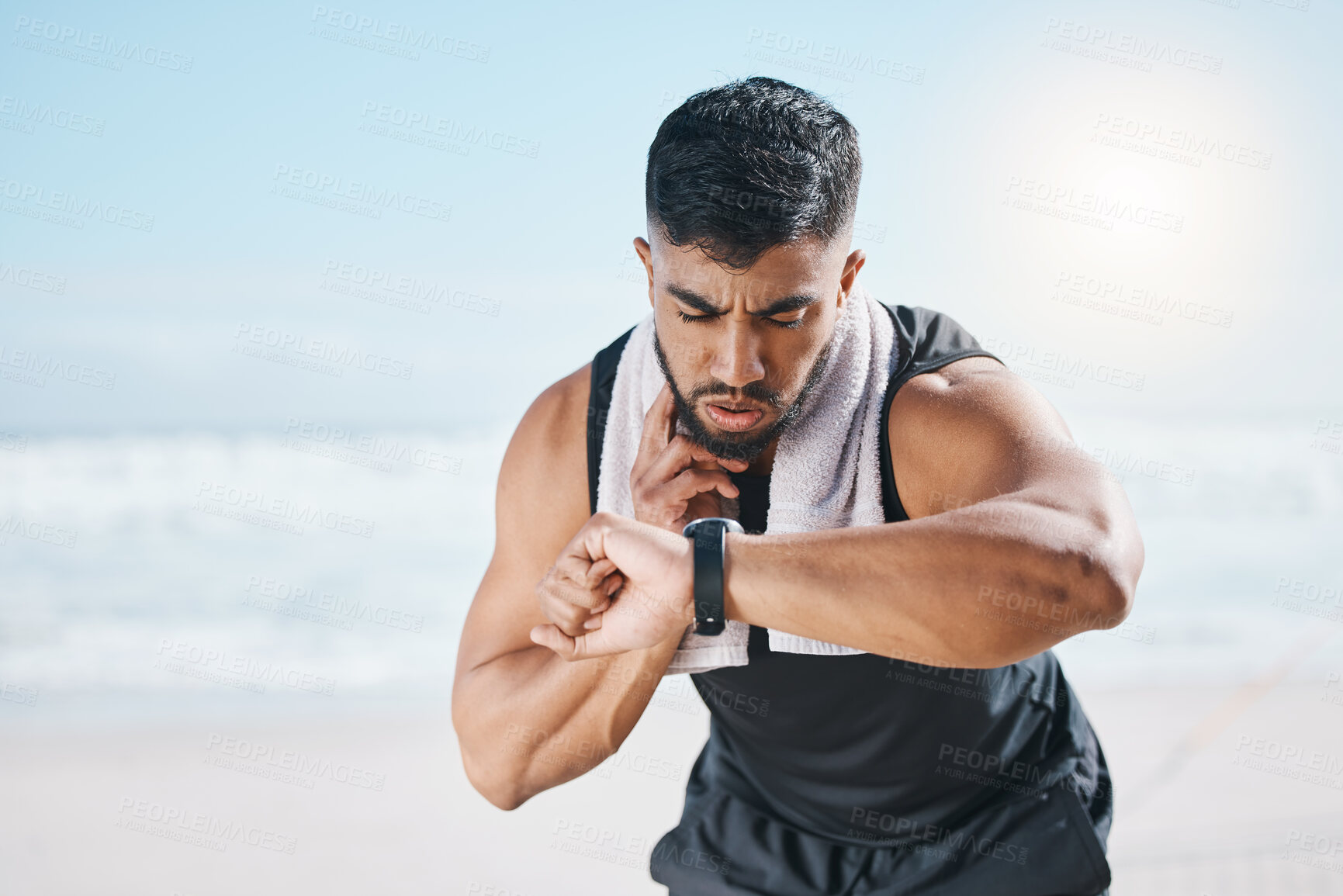 Buy stock photo Man, fitness and checking watch for pulse, heart rate or performance on break after workout on the beach. Fit, active and sporty male person with wristwatch for monitoring body exercise by the ocean