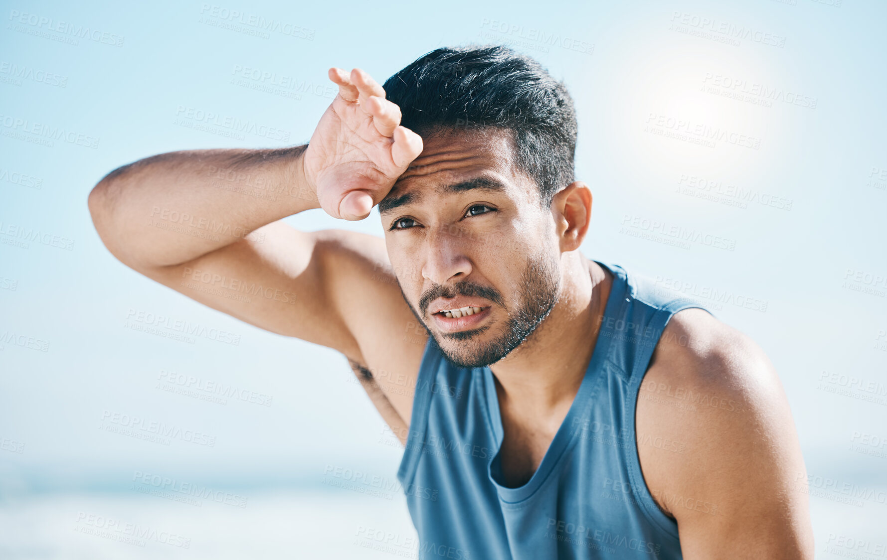 Buy stock photo Fitness, sweating and man breathing at the beach after training, running and intense cardio, focus and resting. Face, tired and male runner stop, sweat and breathe during health workout at the sea