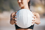 Woman, hands and volleyball in fitness for sports, game or match on beach in training or practice in nature. Hand of active and sporty female person holding ball for playing volley on ocean coast