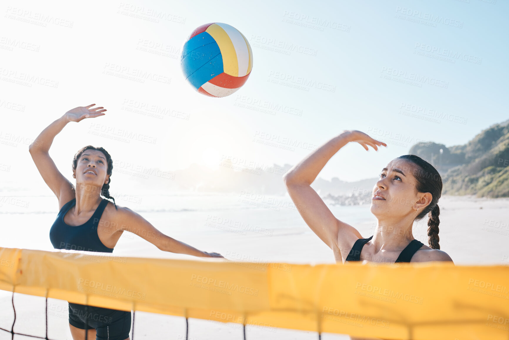 Buy stock photo Woman, volleyball and teamwork in sports game, match or competition together by net in the outdoors. Female person, friends or team playing volley reaching for ball in fitness or athletics in nature