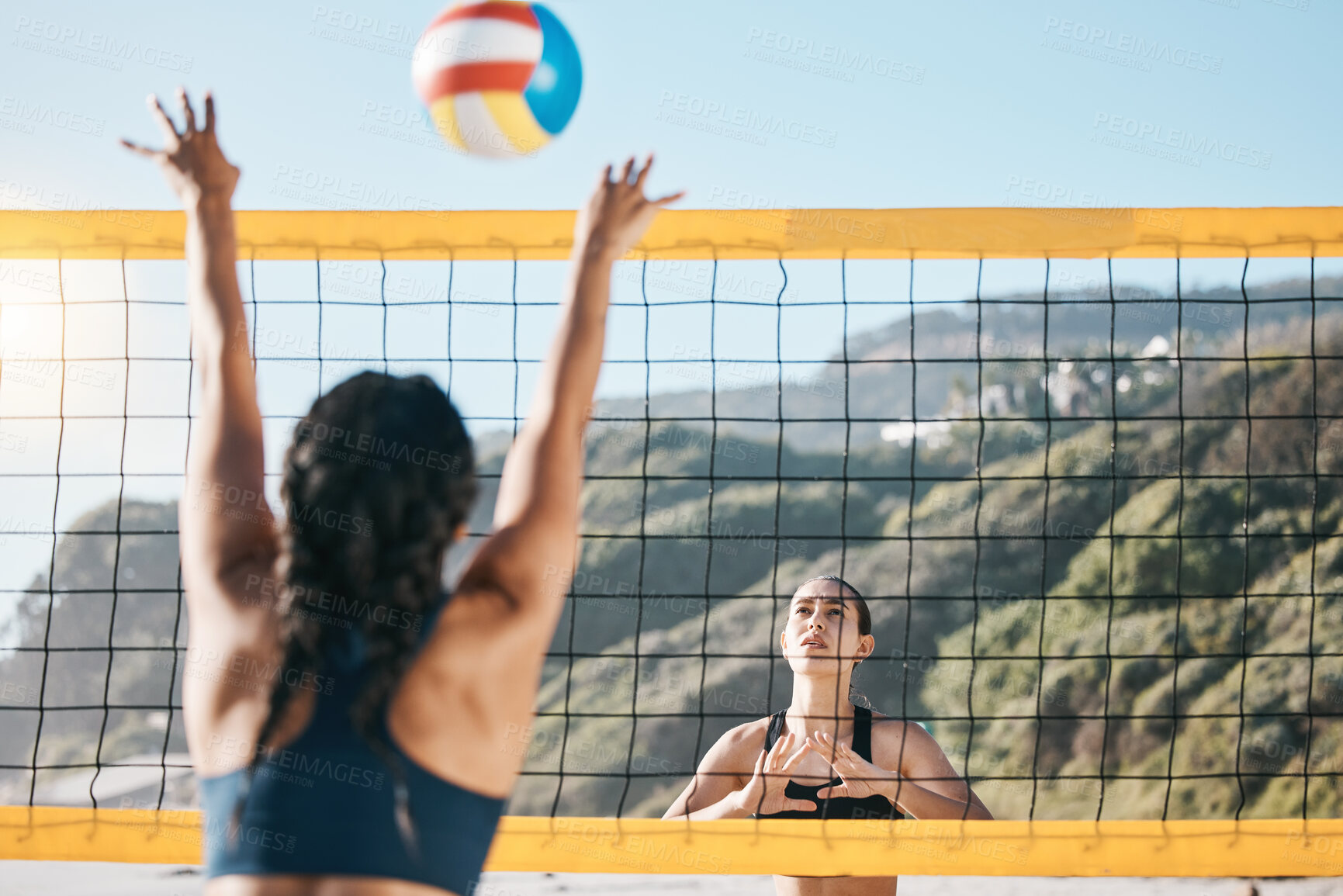 Buy stock photo Volleyball, women and spike, net with sports and fitness outdoor, playing game at the beach at summer. Exercise, female athlete and match with ball and active, workout and action with tournament