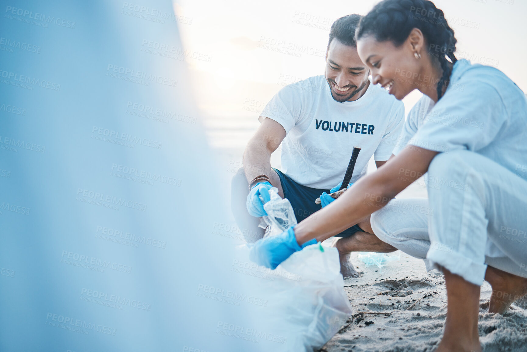 Buy stock photo Volunteer, mockup and people cleaning beach for world earth day, care and kindness for natural environment. Help, recycle and happy man and woman picking up plastic waste and pollution on ocean sand.