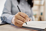 Planning, hands of woman writing in notebook and at her desk in an office for learning. Idea or brainstorming, strategy or notes and closeup female person write in a book for schedule or reminder