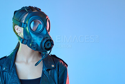 Buy stock photo Mockup, protection and woman with a gas mask, breathing equipment and air pollution against a blue studio background. Female person, model and face cover with climate change, filter and radioactive