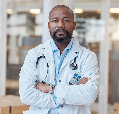 Buy stock photo Portrait, black man and serious doctor with arms crossed in hospital for healthcare. African medical professional, face and surgeon, person or confident employee from Nigeria with wellness career.