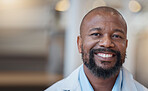 Face, black man and happy doctor in hospital for healthcare, wellness and mockup space. African medical professional, portrait and surgeon, person or employee from Nigeria with smile for health bokeh
