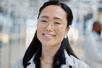 Buy stock photo Asian woman, face and happy doctor in hospital for healthcare, wellness and glasses. Medical professional, portrait and female surgeon, worker and employee with smile for health bokeh in clinic.