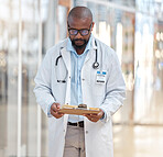 Black man, doctor and reading clipboard with documents of research, healthcare schedule and test results in hospital. Male medical worker with report of insurance, notes and planning info in clinic