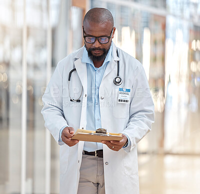 Buy stock photo Black man, doctor and reading clipboard with documents of research, healthcare schedule and test results in hospital. Male medical worker with report of insurance, notes and planning info in clinic