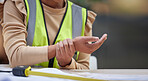 Industry, closeup and female construction worker with wrist pain, injury or accident in her office. Medical emergency, engineering and zoom of a woman industrial employee with a sprain hand muscle.