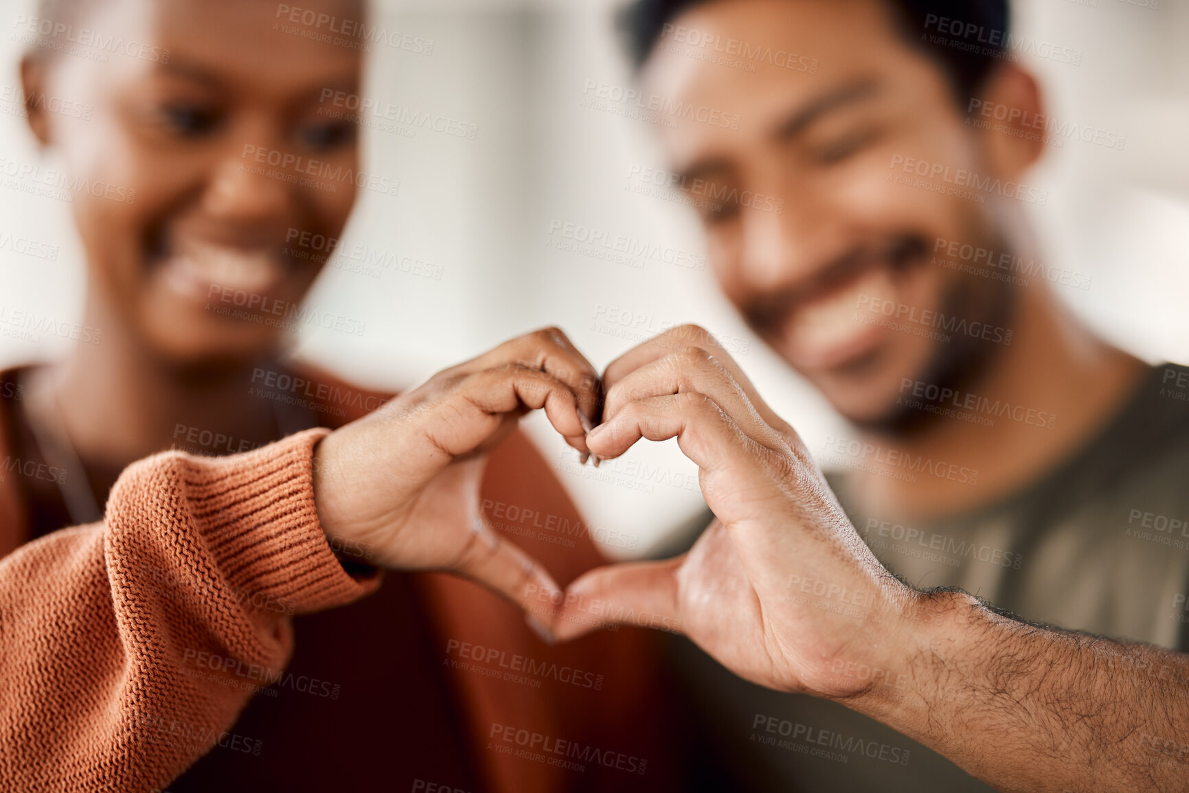 Buy stock photo Love, heart and happy with hands of couple for solidarity, romance and support. Kindness, happiness and relationship with closeup of man and woman with emoji shape at home for care, date and marriage