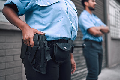 Buy stock photo Hand, gun and security with a police officer on duty or patrol in the city for safety and law enforcement. Legal, service and armed response with a guard outdoor in an urban town for crime prevention