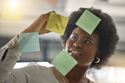 Buy stock photo Black woman, writing or entrepreneur brainstorming ideas on glass board with startup strategy in office. Face, sticky notes or businesswoman planning a schedule, timeline or tasks for company growth