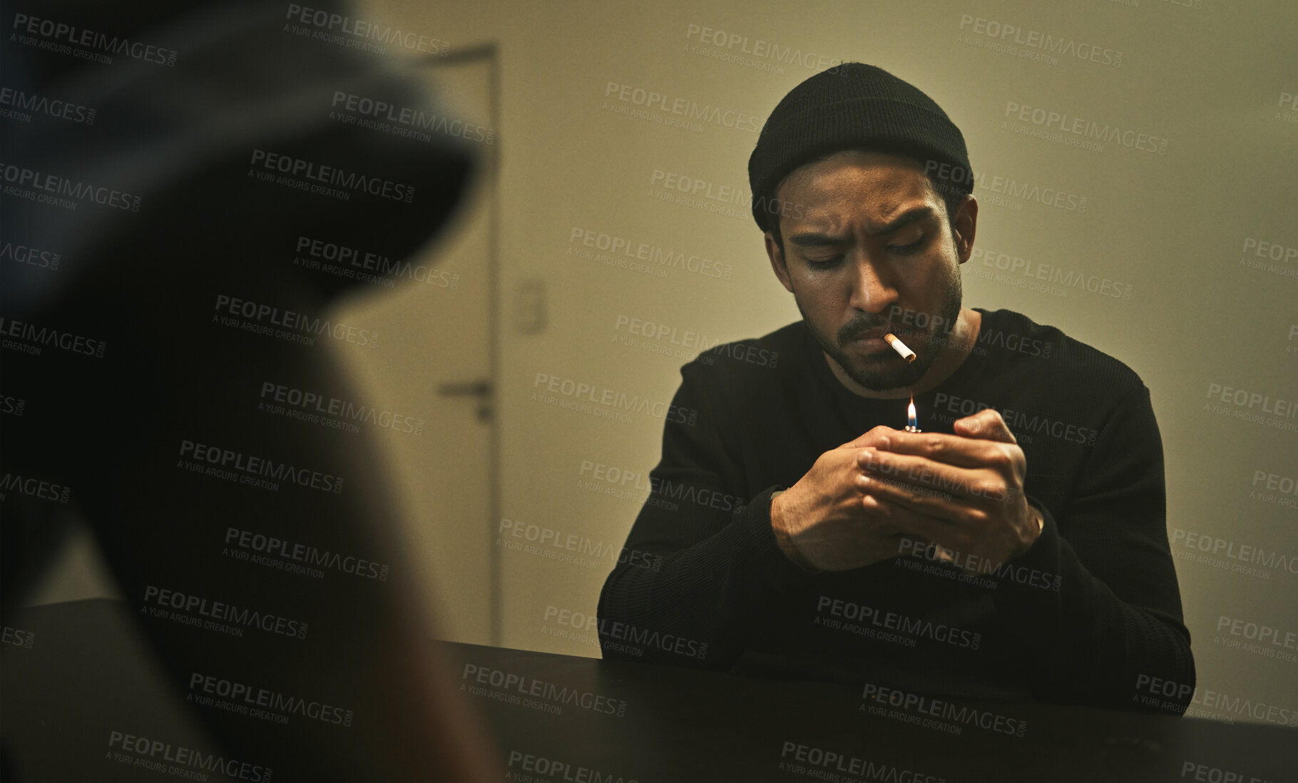 Buy stock photo Man, smoking and talking to police detective in interrogation room with criminal, suspect or interview with a gangster. Security, officer and questioning a person in conversation and investigation