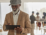 Tablet, research and a senior business black man in the office for planning online against a blurred background. Technology, smile and networking with a happy mature corporate employee at work