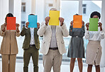 Collaboration, paper and an anonymous business team standing in the office together to show selection options. Teamwork, mockup and color poster with a group of colleagues or employees at work