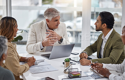 Buy stock photo Businessman, laptop and teamwork with documents in meeting for strategy, planning or proposal at office. Corporate man, senior or CEO talking to team in leadership or training staff at the workplace