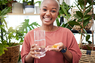 Buy stock photo Portrait, water and medicine with a black woman in her home holding vitamins or supplements for health. Smile, glass and pills with a happy young female person drinking for wellness or hydration