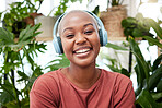 Relax, music and portrait of black woman with plants in home for wellness, happiness and calm. Nature, headphones and face of female person listening to audio with ferns, leaves and house plant