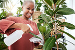 Spray bottle, portrait and woman water her plants for natural growth, development and gardening. Happy, smile and young African female person taking care of green leaves in greenhouse garden at home.