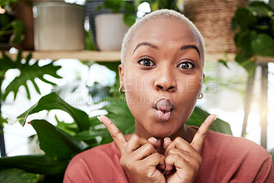 Buy stock photo Black woman, silly face and home with comedy feeling happy with plants. African female person, portrait and crazy with hand sign and funny pout with comic confidence and house greenery with joke
