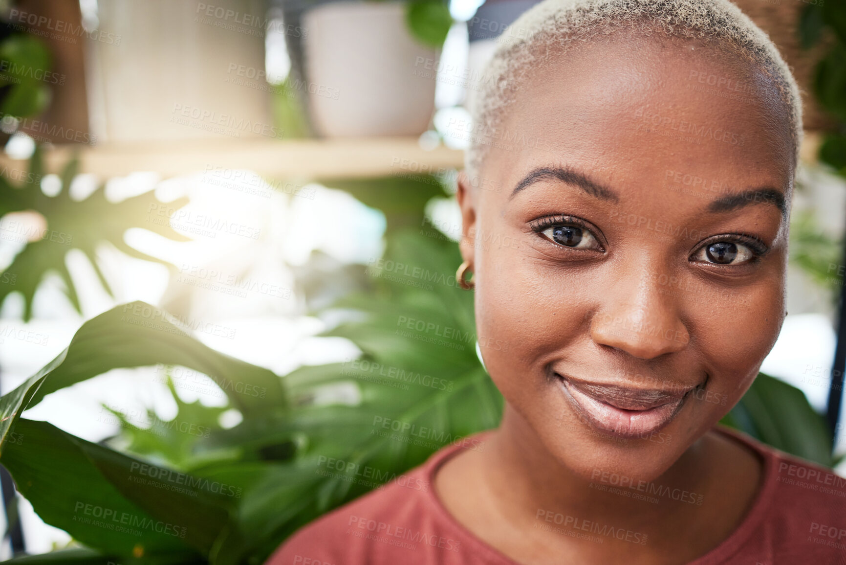 Buy stock photo Portrait, plant and flare with a black woman gardener in her home for sustainability or green growth. Face, beauty and smile with a happy young female person in a nursery for eco conscious gardening