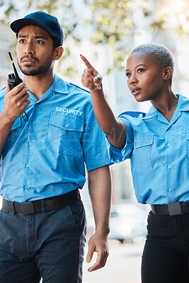 Buy stock photo Security guard, safety officer and pointing on street for protection, patrol or watch for danger. Law enforcement, radio and serious crime prevention man and woman partner or team in uniform outdoor