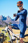 Cycling, mountain bike or man with smartwatch for pulse, exercise or fitness workout goal in training. Neck, biker or sports athlete checking timer to monitor heart rate or progress with online app