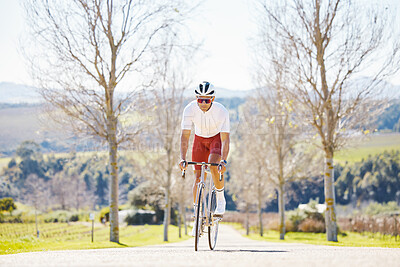 Buy stock photo Sports, cycling and man on a bike in a park for fitness, training or morning cardio routine in nature. Bicycle, exercise and male cyclist riding on path for practice, freedom or performance challenge