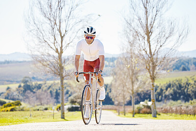 Buy stock photo Fitness, countryside or man cycling on a bicycle for training, cardio workout and exercise outdoors alone. Wellness, healthy or sports athlete riding a bike on a road or path for freedom or challenge