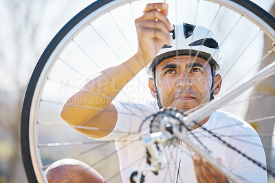 Buy stock photo Fixing, bicycle and a man outdoor with wheel puncture or problem while cycling. Bike, hands and a sports person, cyclist or athlete check for maintenance, safety or repair on broken or flat tyre