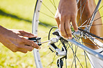 Bicycle, fixing and a man outdoor with wheel puncture or problem while cycling. Bike, hands and a sports person, cyclist or athlete check for maintenance, safety or repair with tools on flat tire