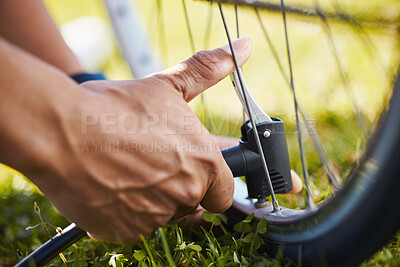 Buy stock photo Fixing, bicycle and a man with air in wheel for maintenance, safety or repair while cycling. Bike, hands and a sports person or athlete with a pump or tools for flat tire or broken transportation