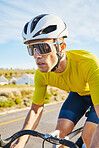 Cycling, sports and man on a bike in road for fitness, training and morning cardio routine in nature. Bicycle, exercise and male cyclist riding outdoor for practice, freedom or performance challenge 