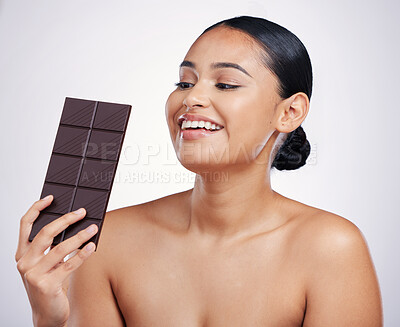 Buy stock photo Chocolate, happy and face of woman in studio with luxury food, sweet treats and candy on white background. Wellness, calories and excited female person holding cocoa bar, sugar snack and dessert slab
