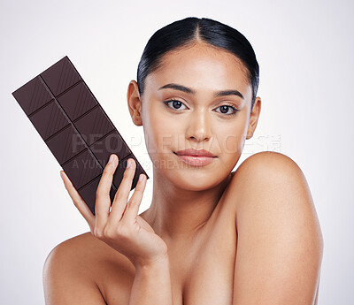 Buy stock photo Chocolate, dessert and portrait of woman in studio with luxury food, sweet treats and candy. Wellness, calories and face of female person holding cocoa bar, sugar snack and slab on white background