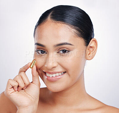 Buy stock photo Woman, beauty and omega in studio portrait for skincare, health or smile for glow, essential oil and white background. Girl, model or happy for supplement, beauty pills or pharma product for skincare