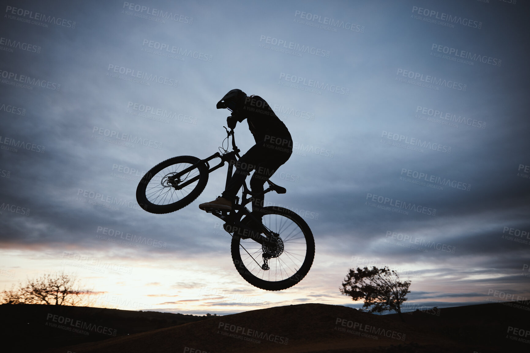 Buy stock photo Motorcycle, sunset and jump with sport with sky or action with training in outdoor for race or risk. Adventure, silhouette and dirt bike with speed in nature with freedom or power in desert on hill.