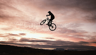 Buy stock photo Sunset, dirt bike and jump with action in outdoor with sport in nature for adventure or risk. Motorcycle, silhouette and freedom with training or sky with speed in desert with person driving.