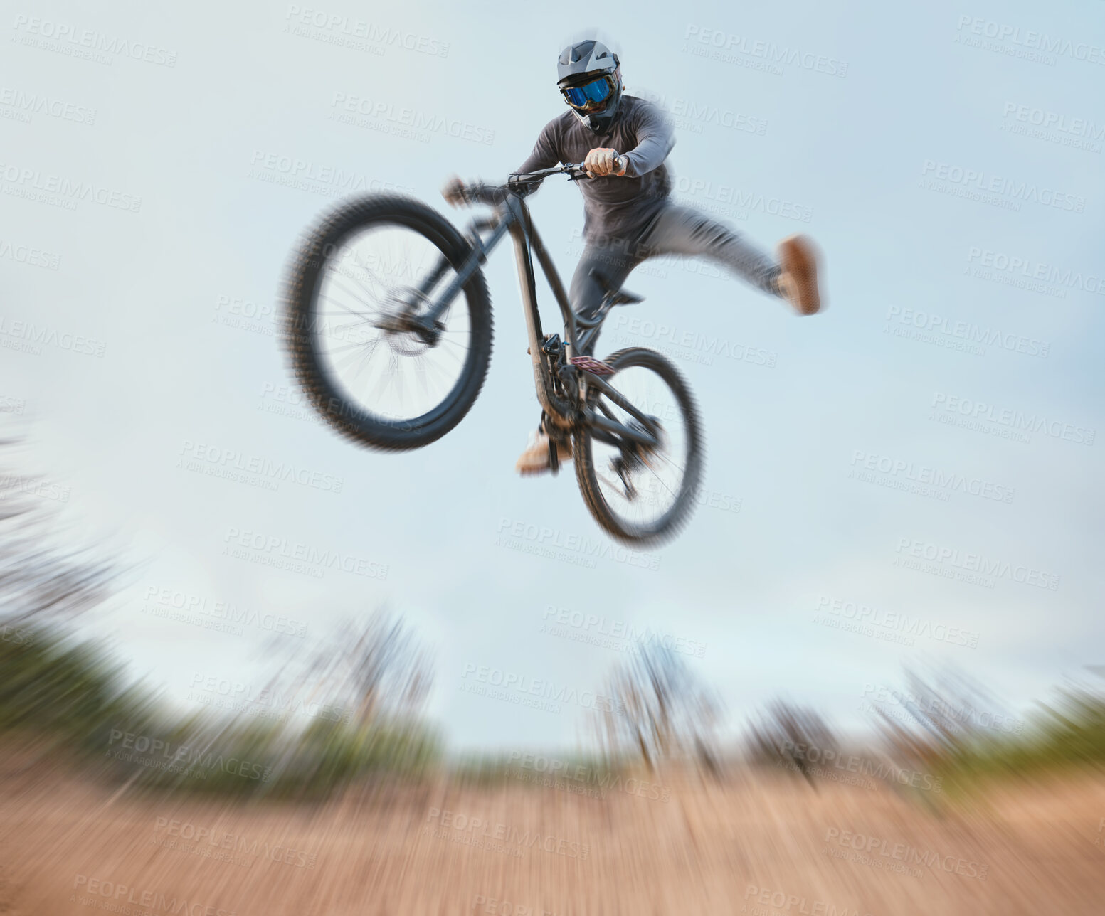 Buy stock photo Mountain, bicycle jump and athlete cycling on a bike for extreme sports competition stunt or training in nature. Skill, contest and person workout or action on sky or air trick for fitness with blur
