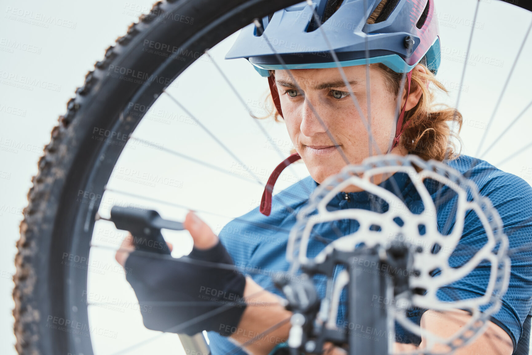 Buy stock photo Bike repair, focus and a man with a wheel in nature for a change, mechanic or travel for sports. Service, professional and a male biker working on a bicycle for riding, cardio or exercise in morning