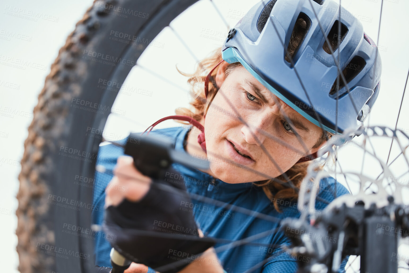 Buy stock photo Bike repair, serious and man with a wheel in nature for a change, mechanic or travel for sports. Service, professional and a male biker working on a bicycle for riding, cardio or exercise in morning