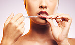 Beauty, lip filler and hands with botox injection, plastic surgery and portrait of cosmetic dermatology  in studio background. Lips of woman, syringe and model with aesthetic facial treatment
