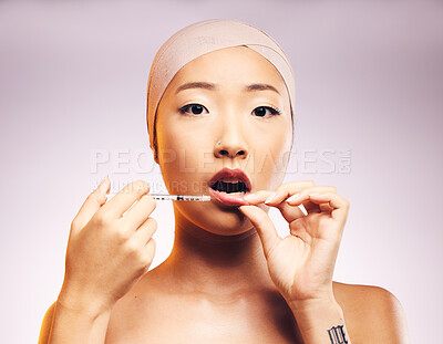 Buy stock photo Beauty, lip filler and woman with injection for plastic surgery and portrait of luxury cosmetic dermatology in studio background. Lips, syringe and Asian model with facial treatment for aesthetic