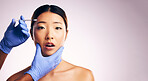 Asian woman, hands and needle for surgery in studio for cosmetic, mockup space or collagen by white background. Beauty, doctor and syringe for patient, dermatology or change for shock, pain and face